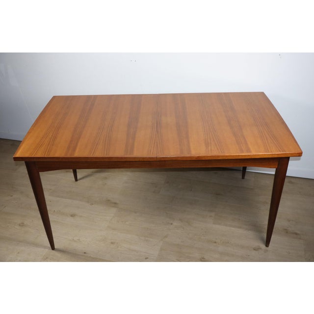 Charming Scandinavian teak dining table from the 1960s, with a simple and timeless design. Its rectangular top showcases a...