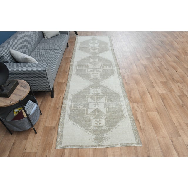 This vintage hand-knotted area rug is a semi-antique vintage area rug. The '70s Eastern region of Anatolian's unique rug...