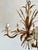Vintage five-light gilt metal chandelier decorated with stylized wheat ears, scrolling leaves, and white floral candle cup...