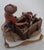 A charming, highly detailed vintage hand-painted Italian Capodimonte porcelain figurine depicting a young boy kneeling...