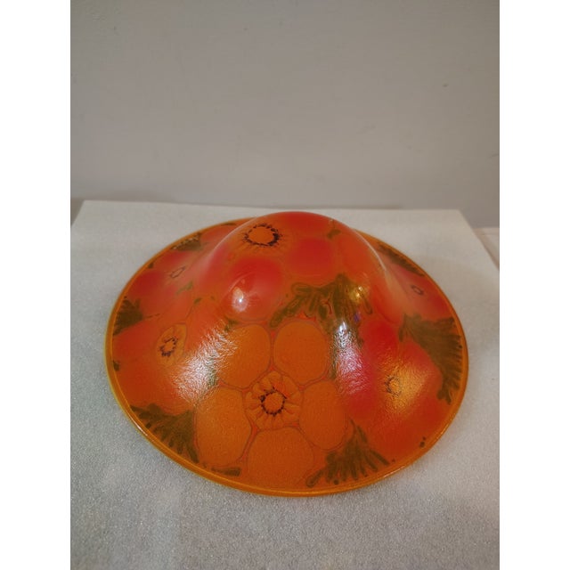 Lovely art glass piece made by Higgins studios with a vibrant orange and yellow flower motif.