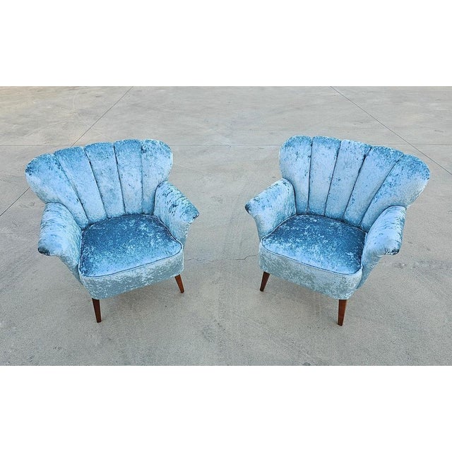 In this listing you will find two extraordinary early Mid Century Modern club or lounge chairs with curved backrest. They...