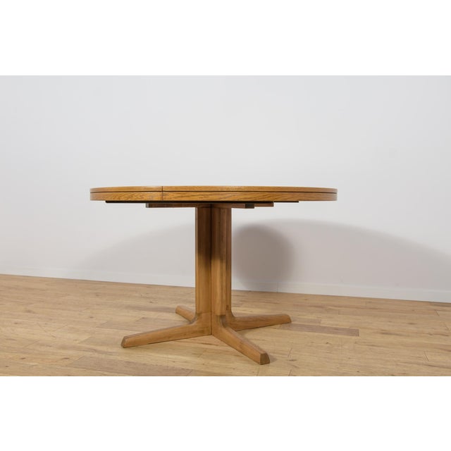 This round extendable dining table was manufactured by the renowned Danish furniture maker Farstrup Møbler in the 1970s....