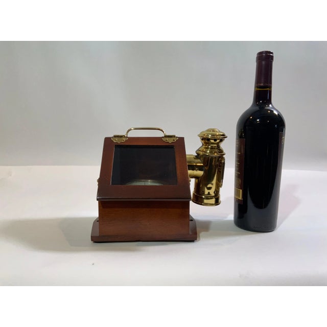 Solid brass yacht compass fitted to a very fine varnished binnacle box with brass hinges and glass door. Also fitted with...