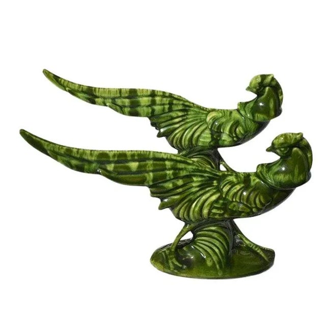 A pair of mcm ceramic glazed pheasant birds in a beautiful deep green. Each bird features a long outstretched tail and...