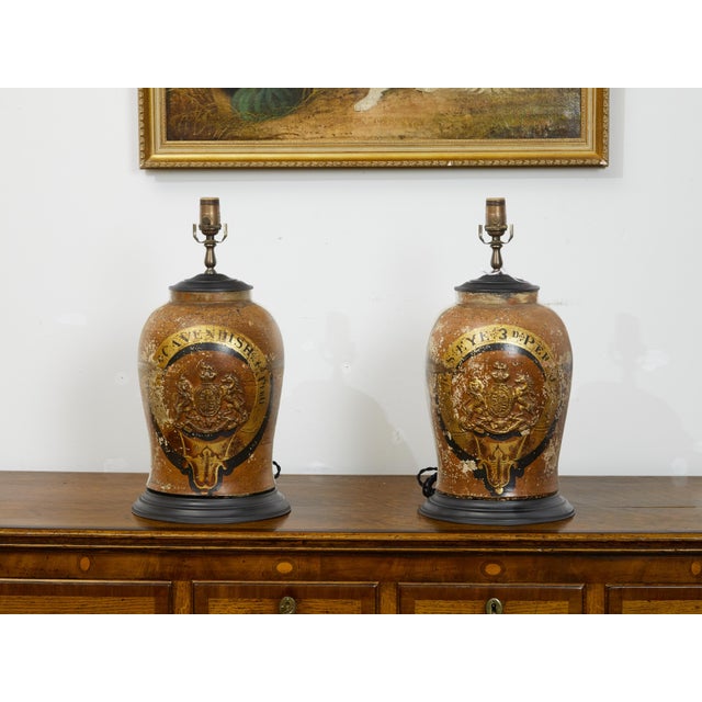 A pair of English stoneware from the late 19th century, with coat of arms made into table lamps. Created in England during...