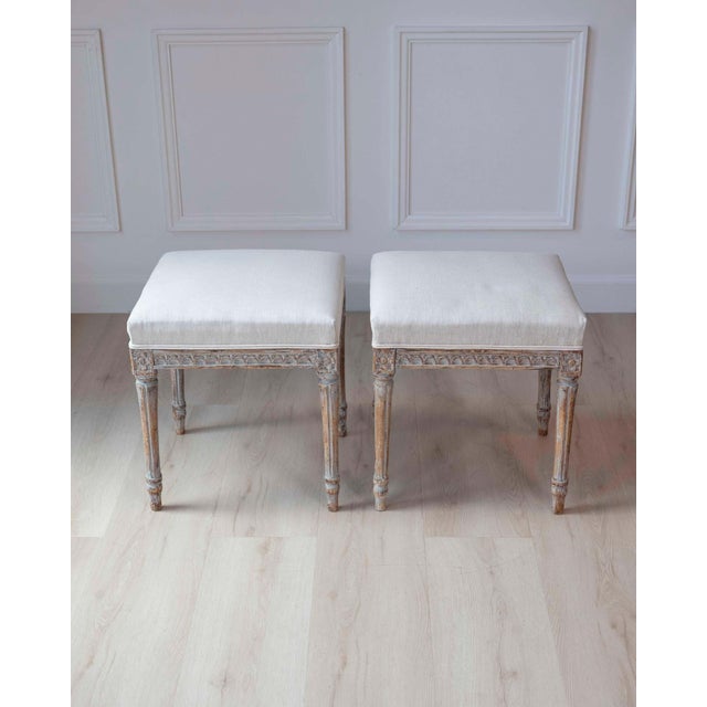 A refined pair of Swedish stools dating to the 18th century, executed in the elegant Gustavian style. Their clean...