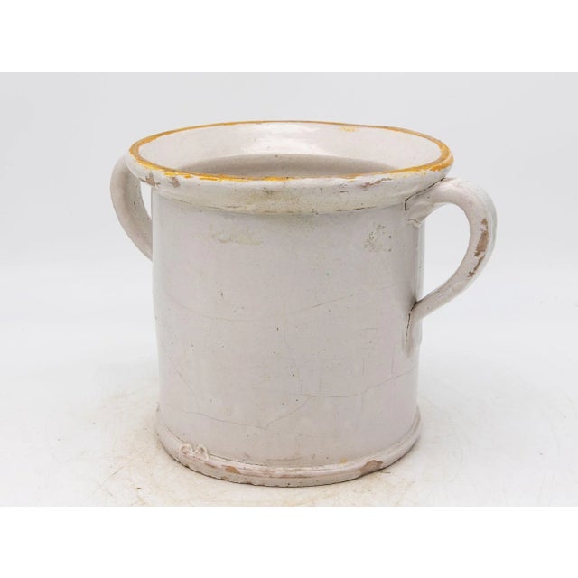 This 19th-century French confit pot features a classic glazed stoneware body with traditional dual handles, both...