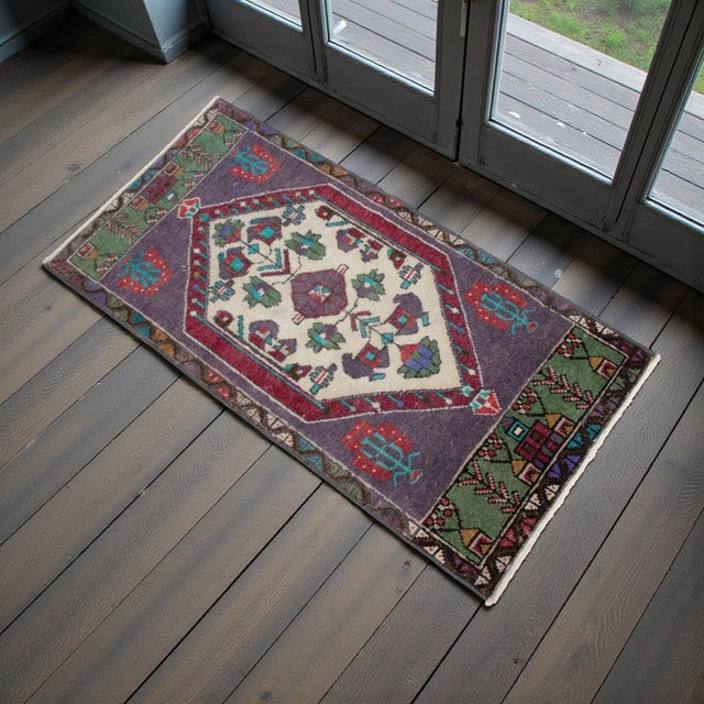 Welcome a touch of Anatolian charm into your home with this exquisite handcrafted small vintage rug. Its versatile size...