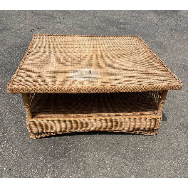 Gorgeous coastal chic 1980's Lloyd Flanders woven wicker coffee table in a sought after generous square shape featuring...