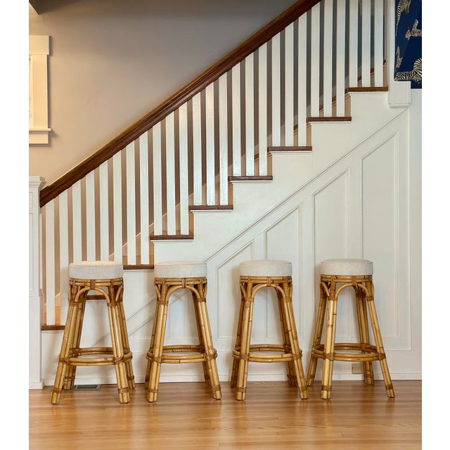 We are very pleased to offer a beautiful set of four vintage rattan barstools by Calif-Asia, circa the 1970s. Featuring...