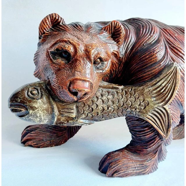 Large walking black forest bear with fish on mouth. Special carved, solid Wood. Mahogany patina. Wonderful for decoration...