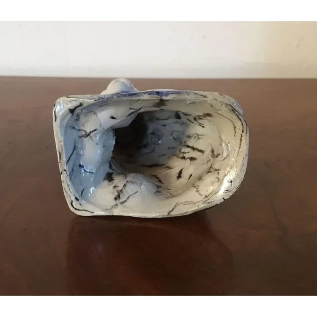 Staffordshire white salt glazed stoneware solid agate model of a cat, England, c. 1740. The press-molded body marbled in...