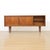 This mid-century credenza was produced by Elliots of Newbury the 1960s. Featuring distinct sliding doors, with two large...