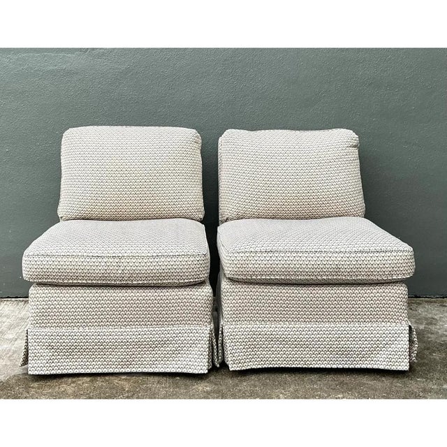 This pair of vintage slipper chairs combines a classic armless silhouette with a beautifully tactile woven fabric. The...