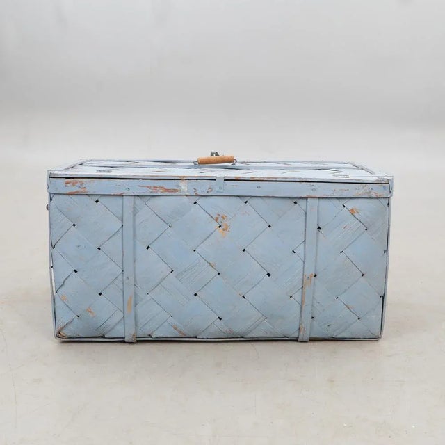 A basket in the form of a case from around 1880 is offered here. The piece was worked from different stripes, better...