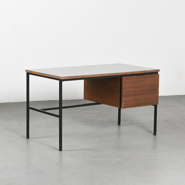 An elegant modernist desk, model 620, designed by Pierre Guariche and produced by Minvielle in the 1950s. The square-...