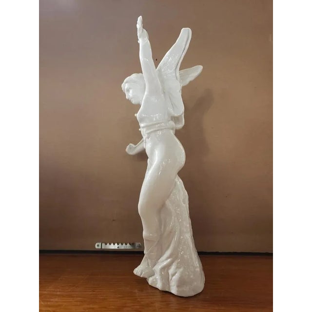 This Late 19th Century Old Paris Porcelain Greek Goddess Nike Figurine measures 11 1/2" high, 4 1/2" wide and 4 1/4" deep.