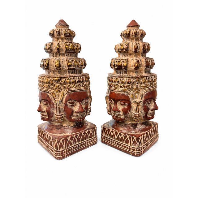 Striking pair of vintage Southeast Asian-inspired four-faced temple sculptures crafted of substantial, heavyweight resin....