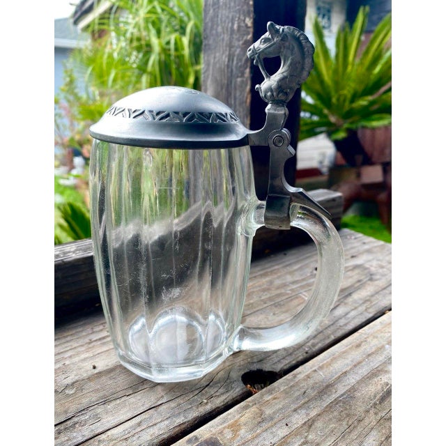 A handsome antique European beer stein dating to the late 19th or early 20th century, distinguished by an unusually...