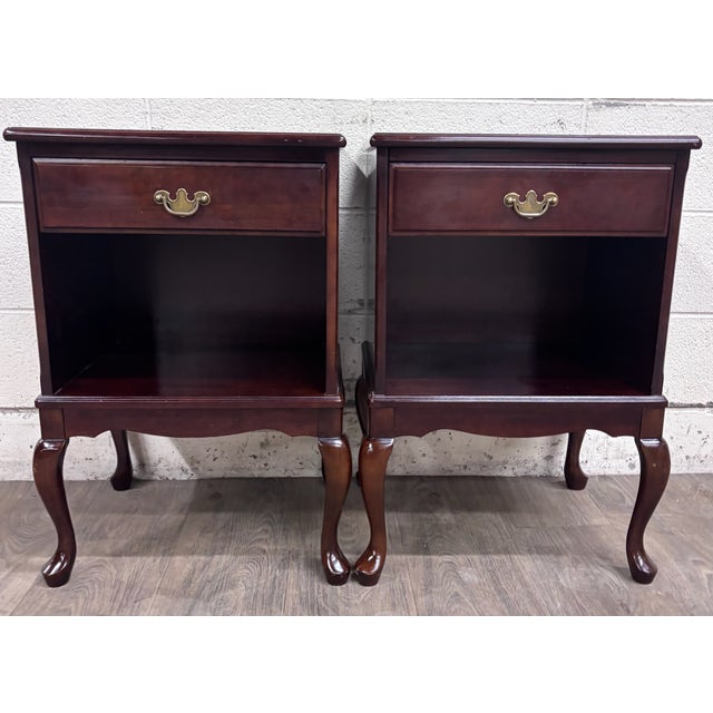 This is a gorgeous matching pair of 1991 Bombay Company nightstands or side tables, made in Malaysia. Finished in a rich...