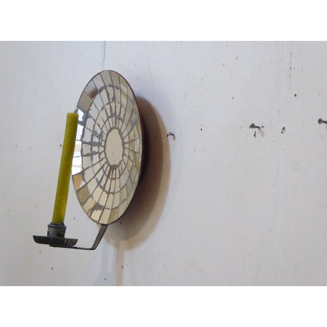 This sconce has a mirrored backplate that measures 11.5" Diameter.
