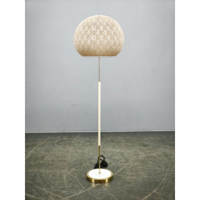Original Mid-Century Modern floor lamp produced in Germany during the 1960s. Featuring a refined combination of lacquered...