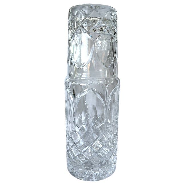 A beautifully weighted cut glass bedside water carafe and tumbler set, featuring deep diamond cuts, elongated Gothic...