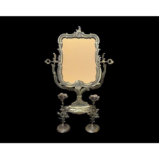 A three-piece handmade brass vanity set featuring an adjustable tabletop mirror and a matching pair of floral...
