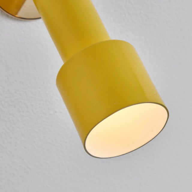 1960s Tito Agnoli perforated yellow metal & brass sconce for O-Luce. These iconic sconces are executed in yellow painted...