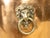 An English copper and brass cache pot planter from the early 20th century, with lion paw feet and lateral lion head...