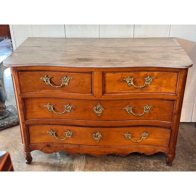 18th century French Louis XV walnut commode with a serpentine front of two short drawers over two long drawers, each set...