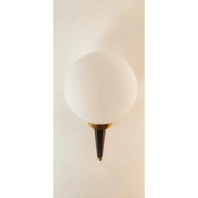 Gold and Black Wall Light with White Sphere from Stilnovo, in Very Good conditions. Designed 1970 to 1979 This piece is...