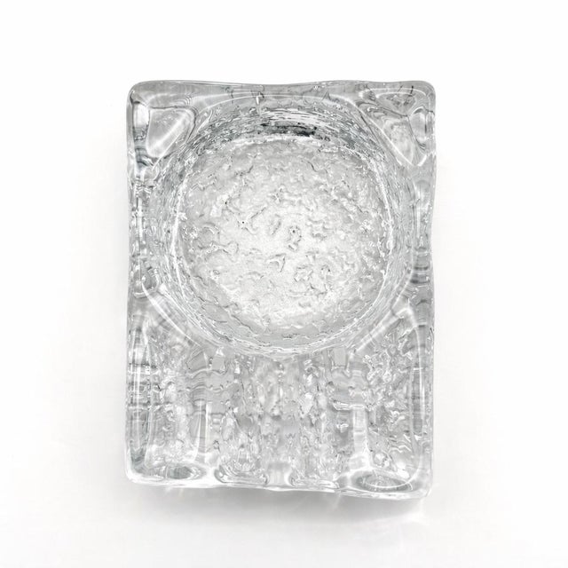 A striking Scandinavian modern ice-textured glass ashtray featuring a bold rectangular form and deeply textured,...