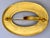 A handsome antique bright gold gilded brass buckle brooch with raised flourish designs on two sides.