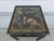 A Mid-Century Modern black lacquered Chinoiserie side table by Drexel. This piece features traditional landscape scenes on...