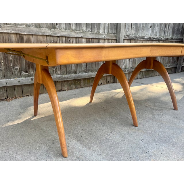 One of the all-time classic Heywood Wakefield pieces, the model M167G dining table. Extends from 28 inches to 94 inches...