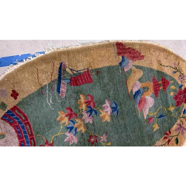 Handmade antique Art Deco Chinese rug in green and yellow shades. The rug is from the beginning of 20th century in...