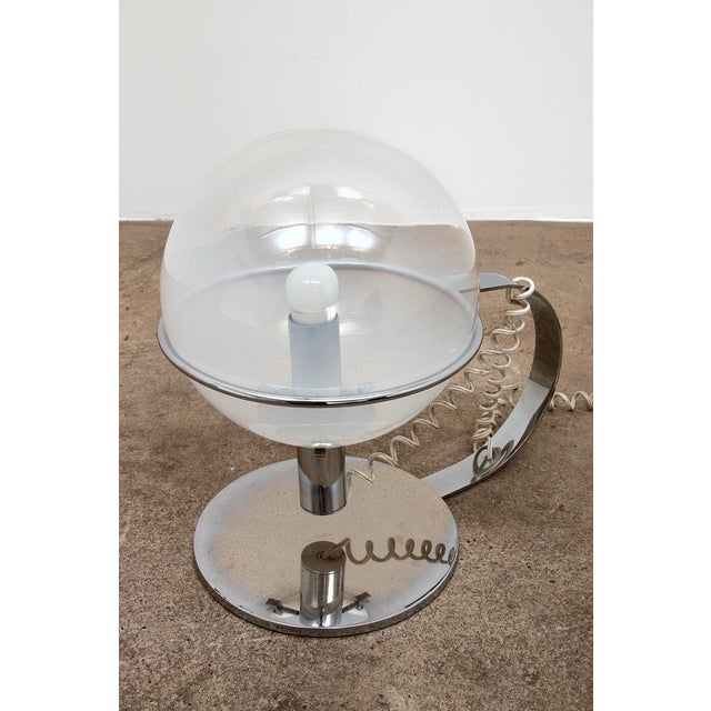 Beautiful table lamp made of chrome with a ring in which a mouth-blown Murano sphere lights up. You can play with this...