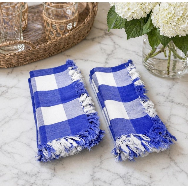 A crisp set of six vintage blue and white gingham cotton napkins finished with soft fringe edges. The oversized cobalt...