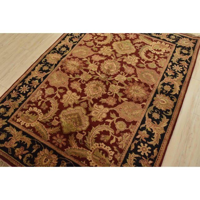 A traditional Agra rug is hand-knotted with an all-wool pile on a cotton foundation. This finely woven oriental rug...