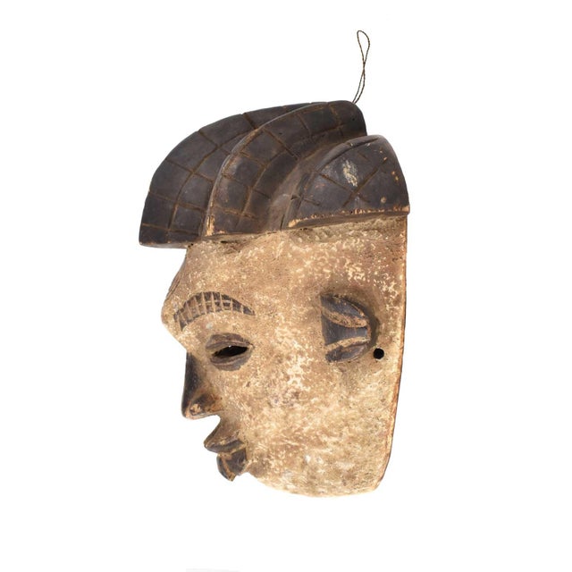 This mask is used by various tribes in Gabon. This one comes from the Punu. Mmwo Spirit Maiden Mask portrays a beautiful...