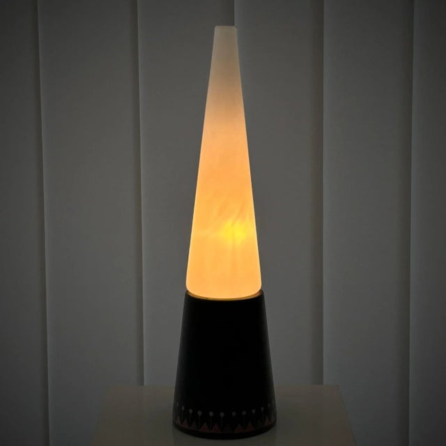 Mid-century table lamp designed and produced by Hans-Agne Jakobsson, Sweden, 1950s. The lamp features a conical base made...