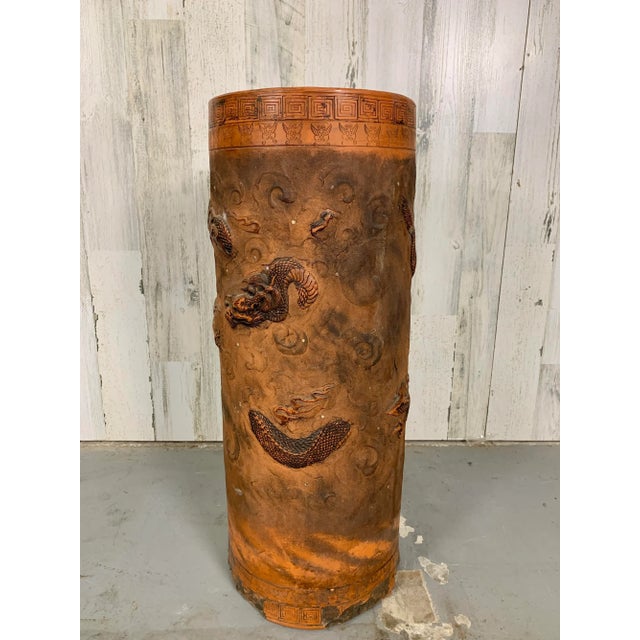 Early 20th century Terra cotta stand is hand crafted with paint along the Greek key boarder and on the dragons. On the...