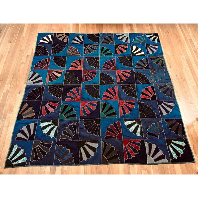 An antique hand-made quilt circa 1890-1900s originated from Ohio. The quilt features a striking patched square pattern...
