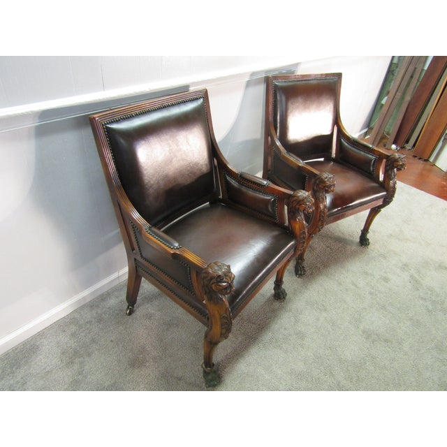 Item 87149: Theodore Alexander pair of solid mahogany carved leather chairs. Age: 2000's. Details: Carved lions heads....
