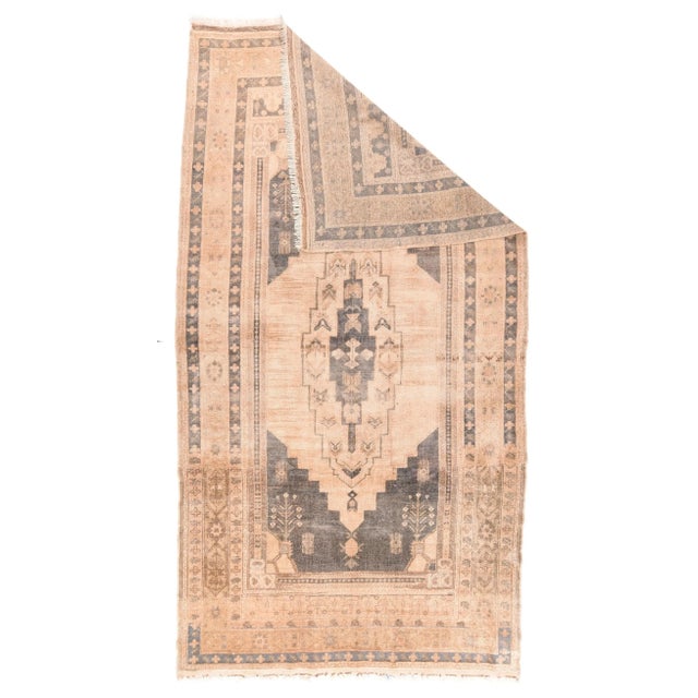 The mauve-brown field displays a stepped sand sub-field centred by a tall, widely stepped ecru cartouche medallion. Small...