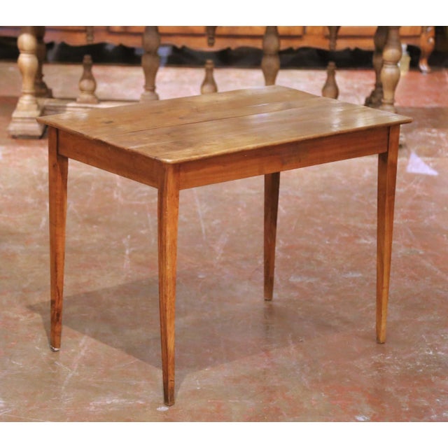 Crafted in France circa 1850, this elegant antique Louis Philippe table is built in solid wild cherry, a wood favored in...