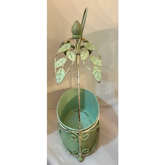 Pretty green and off white metal 2 piece planter. Bucket sets in wire framing with ball feet. Perfect garden decoration....