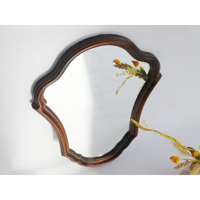A vintage scalloped wooden wall mirror made in the Netherlands in the 60's. The beautiful mirror has a nice carved frame...